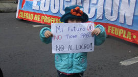 Niña con cartel de "Mi futuro no tiene precio. No al lucro!"